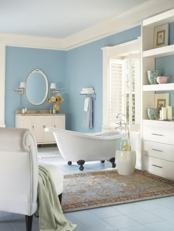 ivory as the main shade, blue as the secondary and some tan touches to make up a welcoming bathroom