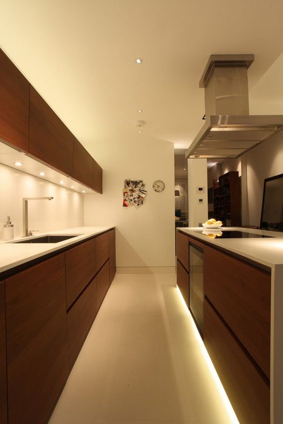 strip lighting under the lower cabinets is a cool idea to give an edge to your kitchen