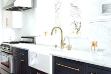08 a chic black and white kitchen with gold hardware and matching lamps over the basin