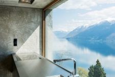 08 a kitchen with an unframed and uncovered view of a mountain lake inspires to create a culinary masterpiece
