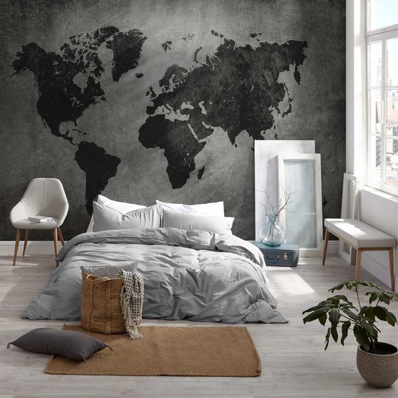 a minimalist bedroom with a dark world map mural as a decor statement in the space