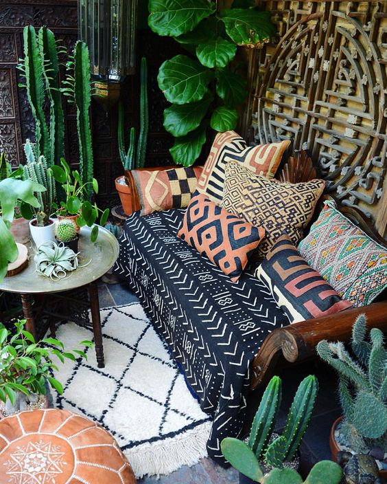 Printed colorful pillows and matching sofa upholstery make the space boho like