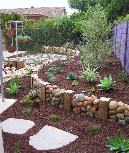 a gabion wall used as garden edging blends with the natural environment making it fresh and cool