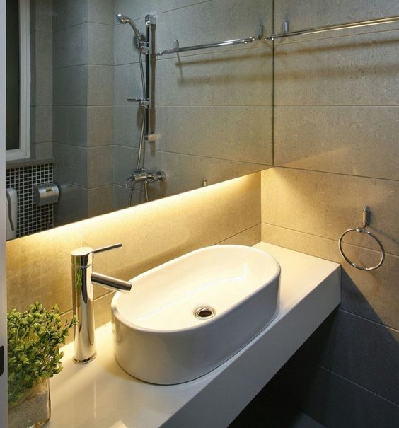 strip lighting attached to a mirror cabinet over the sink is a stylish modern decor idea for a bathroom