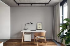 11 There’s also a home office space by the window, with a sleek white desk and a chair