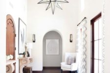11 a neutral and light-filled entryway with an oversized star-shaped chandelier for a statement