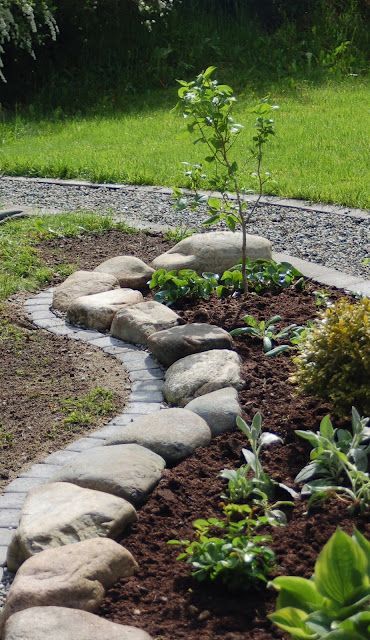 large rough rocks doubled with bricks make the garden look elegant and natural at the same time
