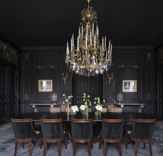 a large vintage chandelier over the moody dining room is a gorgeous idea for more light and to highlight the decor