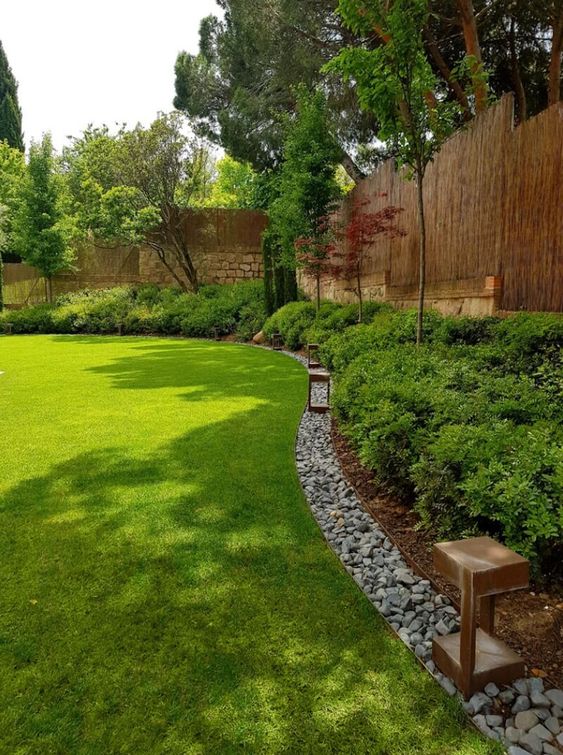 rock edging adds texture to the landscape design and separate the shrubs and the lawn