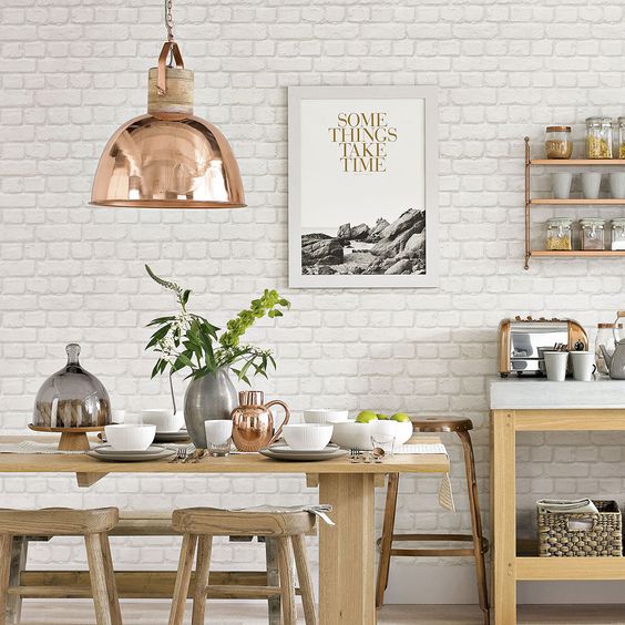 a Scandinavian kitchen with a white brick wall and neutral furniture, copper touches for a serene feel