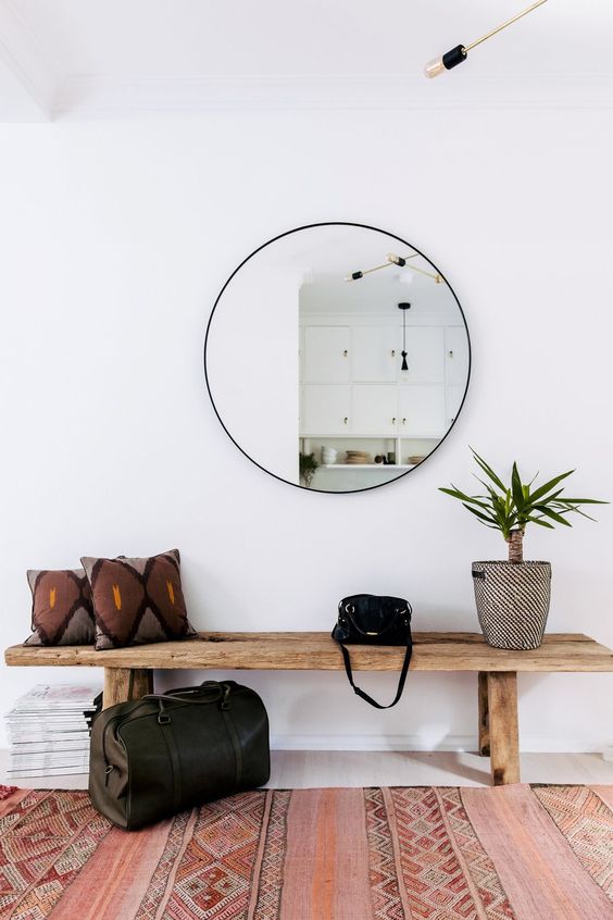 a round mirror is a trendy decoration and a piece that doubles the light coming to the entryway