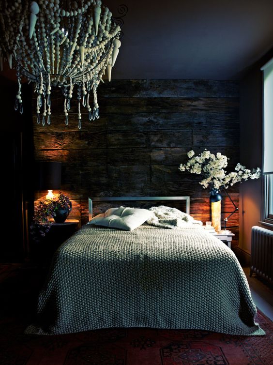 some wall and table lamps in this dark and moody bedroom create a cozy ambience and you'll want to stay here longer