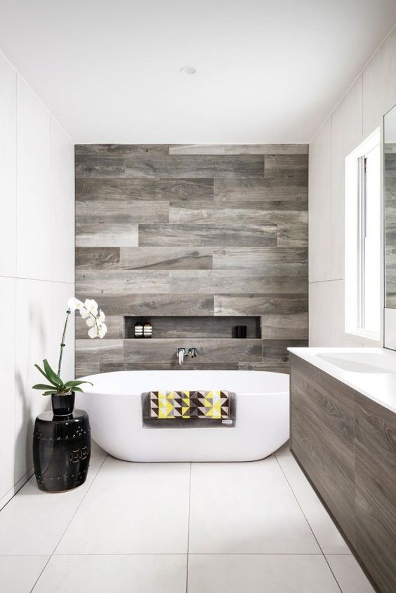a contemporary bathroom with reclaimed wood touches and negative space for a relaxing feeling
