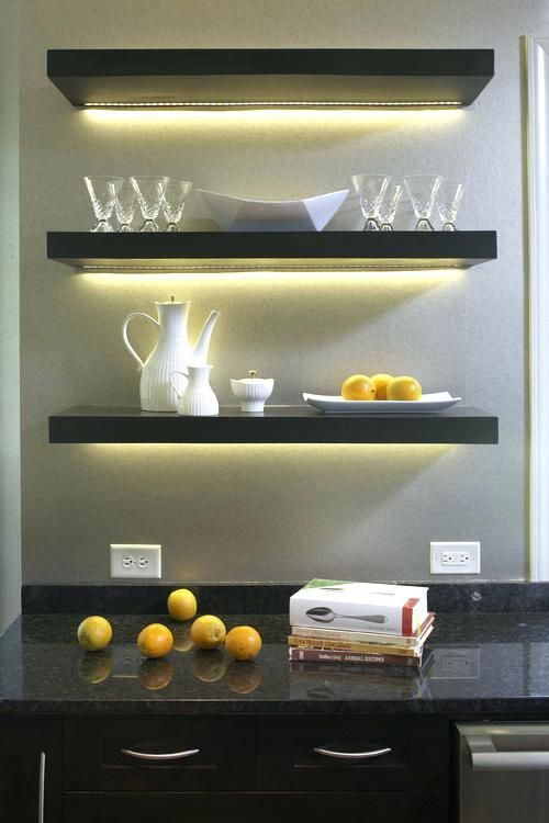 a simple home bar with open shelves highlighted with strip lighting that accent this space a lot