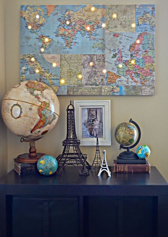 a world map collage with LED lights in the places where you've already been is a very inspiring wall art idea