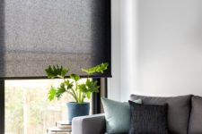 15 black rolled shades of translucent fabric is a stylish way to add a touch of dark color and block the light without going too moody