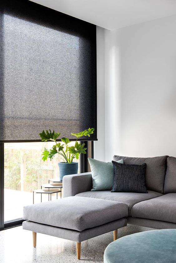 black rolled shades of translucent fabric is a stylish way to add a touch of dark color and block the light without going too moody