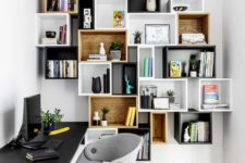 15 mismatching box wall-mounted shelving units double as decoration in a home office