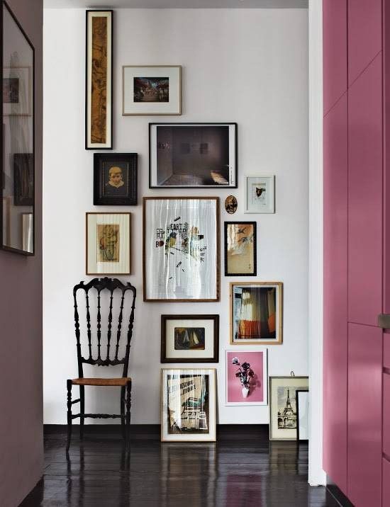 a catchy floor to ceiling gallery wall with mismatching frames and a very narrow artwork will make a statement
