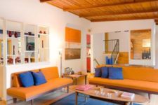16 a super bright orange and blue living room calmed down with neutrals is a bold idea