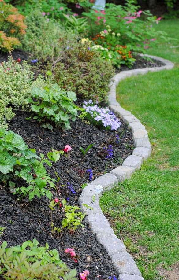 traditional stone edging always works for most of gardens - it's neutral and timeless, besides it's very durable