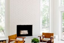17 a chic mid-century modern nook with a white bricck clad fireplace that looks bright and chic