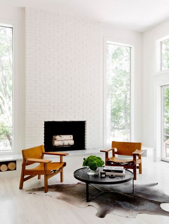 A chic mid century modern nook with a white bricck clad fireplace that looks bright and chic