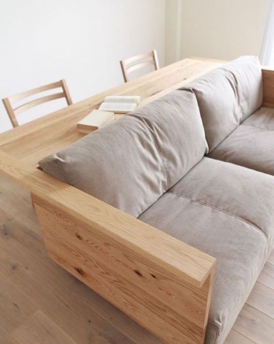 a sofa with a desk or console attached to the back is a cool way to save some space