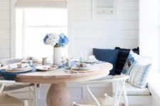 18 a nautical breakfast nook with wishbone chairs, white shiplap walls and a round vintage dining table