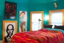 18 a turquoise bedroom is accented with red bedding and bright yellow framing of the windows