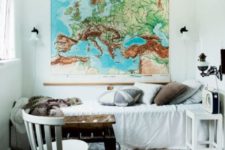 18 a vintage industrial guest bedroom with a large map as an artwork that inspires travelling