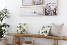 19 a coastal entryway with a beach-inspired gallery wall and some tropical pillows for a match