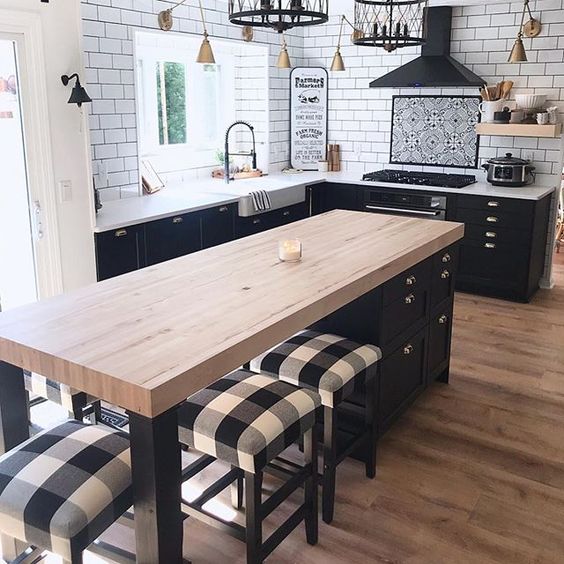 a farmhouse kitchen in black and white with buffalo check printed stools