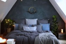 19 a moody attic bedroom is refreshed with candles and lights hanging over the bed itself