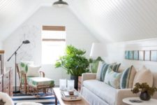 19 a small attic and beachy living room done with white shiplap on the walls and ceiling, neutral furniture and a striped rug