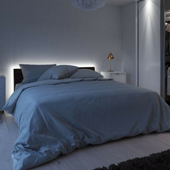 a bed with headboard with strip lighting creates a relaxed mood in the bedroom and you won't need any additional lamps