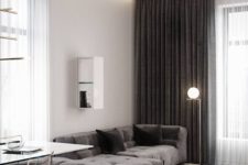 20 a contemporary home with dark contrastign features – a stone coffee table, dark curtains and upholstery