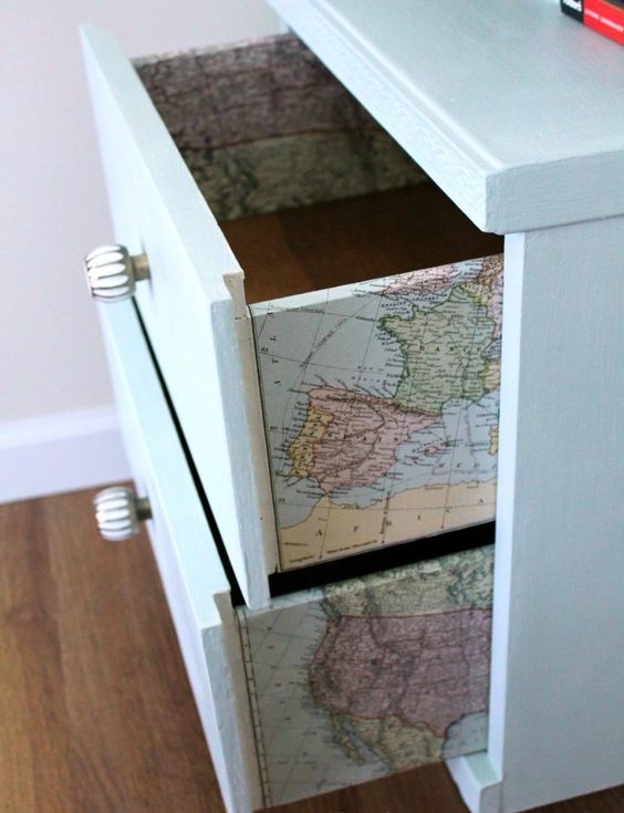 A dresser with vintage maps decoupaged is a fun idea that doesn't look too much   only for travel maniacs