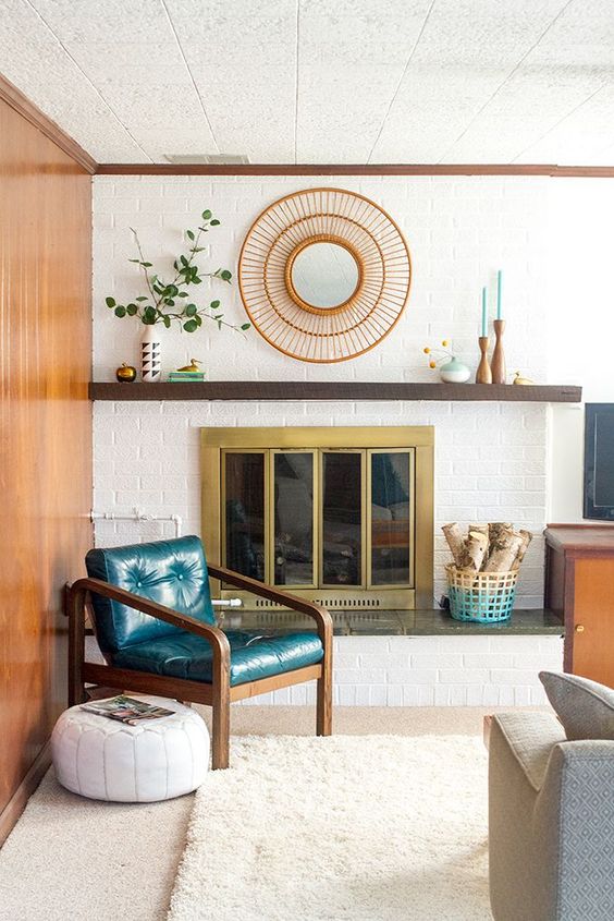 a mid-century modern living room with a white brick clad wall and touches of color to highlight it