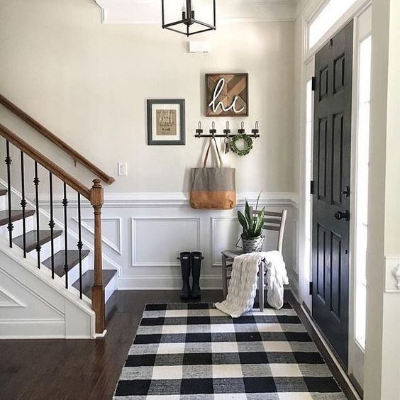 a small farmhouse entryway with a buffalo check rug, which is a cool idea to highlight the style