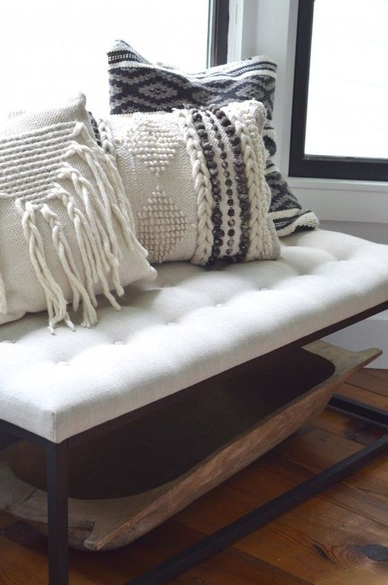 cozy macrame and braided pillows on an entryway bench will make your space very welcoming