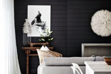 21 a stylish contemporary living room highlighted with black shiplap on the wall, neutral furniture accents it even more