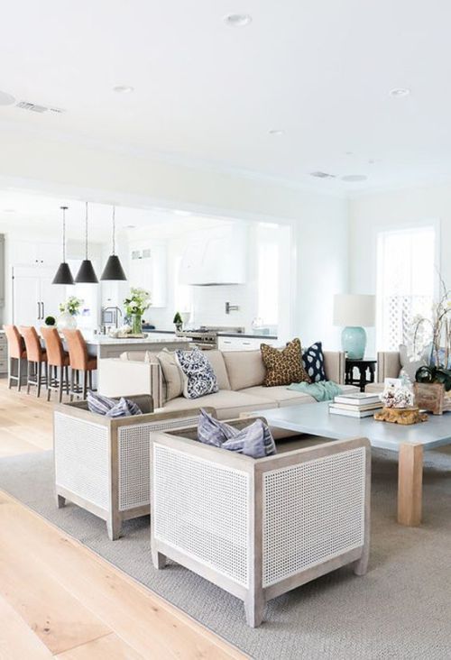 some tan cane chairs and a frosted glass and wood coffee table make up a chic modern lounge