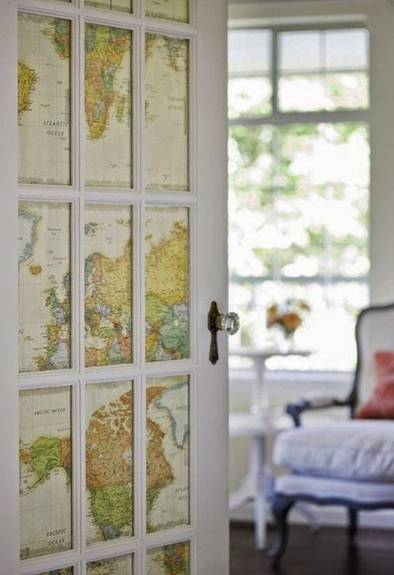 a door done with world maps instead of usual glass is a gorgeous travel-inspired idea to go for