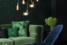 22 a refined living room with dark green, emerald and navy plus a cluster of brass pendant lamps