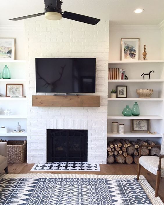 A farmhouse living room with a white brick wall and touches of wood and wicker for coziness