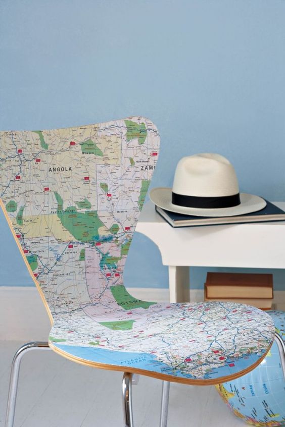 a modern chair covered with a world map is a cool and fresh idea for those who love to wander