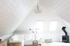 24 a white attic living room all done with white shiplap around and stained shiplap on the floor looks very cozy and airy