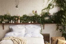 24 an open shelf with potted greenery and soem vines climbing up the wall is a great idea for a boho bedroom