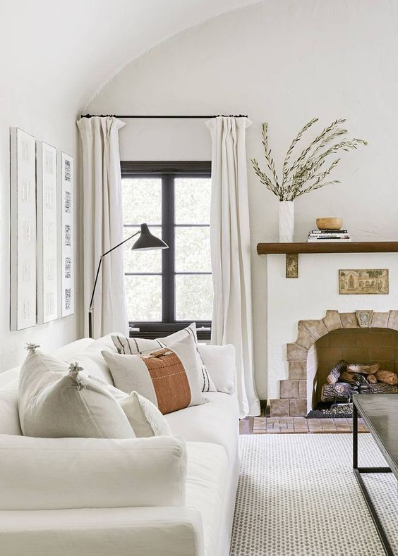 A 1920s Spanish inspired living room with layered neutrals done in an analogous color scheme
